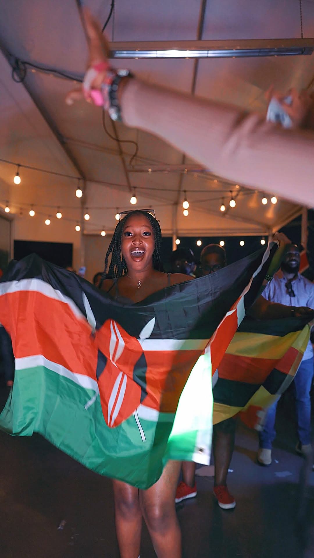 Guest holding East African flags